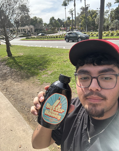 Customer holding Better Than Honey organic molasses outdoors