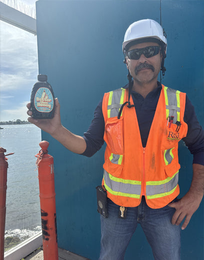 Worker holding Better Than Honey blackstrap molasses bottle