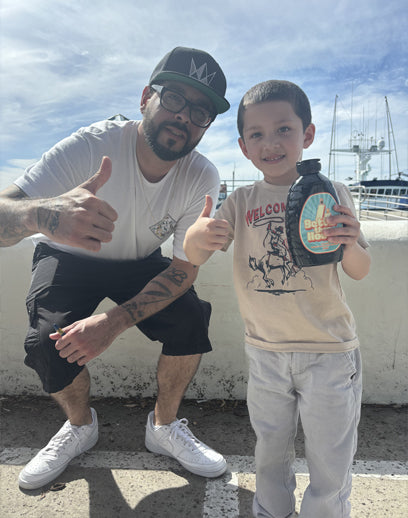 Kid holding Better Than Honey molasses bottle
