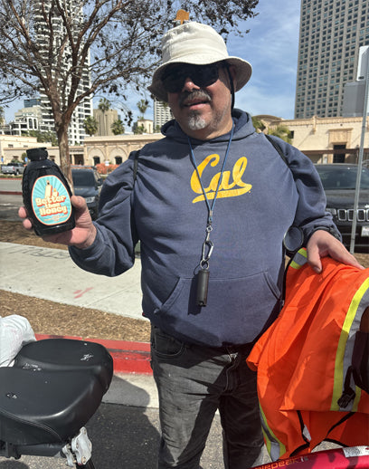 Biker holding Better Than Honey molasses bottle